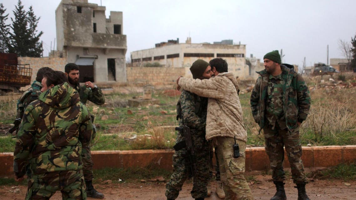 Syrian government soldiers celebrate after taking control of the village of Ratian, north of the embattled city of Aleppo, from rebel fighters on February 6, 2016. AFP