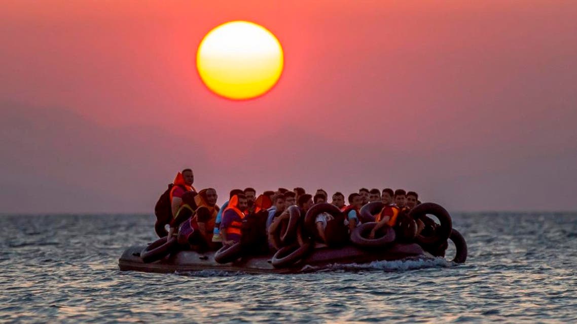 Migrants on a dinghy arrives at the southeastern island of Kos, Greece, after crossing from Turkey, Thursday, Aug. 13, 2015. (AP)