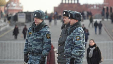 Russian police officers patrol at Red Square with the Lenin Mausoleum in the background, in Moscow, Russia, Saturday, March 3, 2012. (AP)