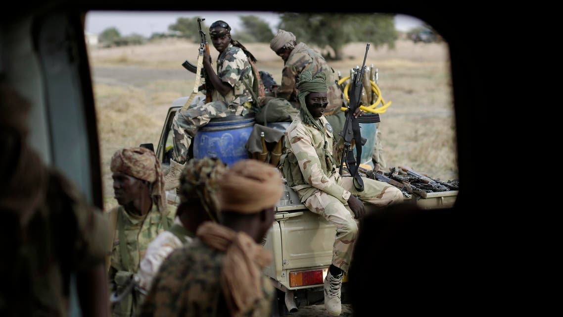 Chadian soldiers transfer weapons seized from Boko Haram fighters to a helicopter in the Nigerian city of Damasak, Nigeria, Wednesday March 18, 2015.