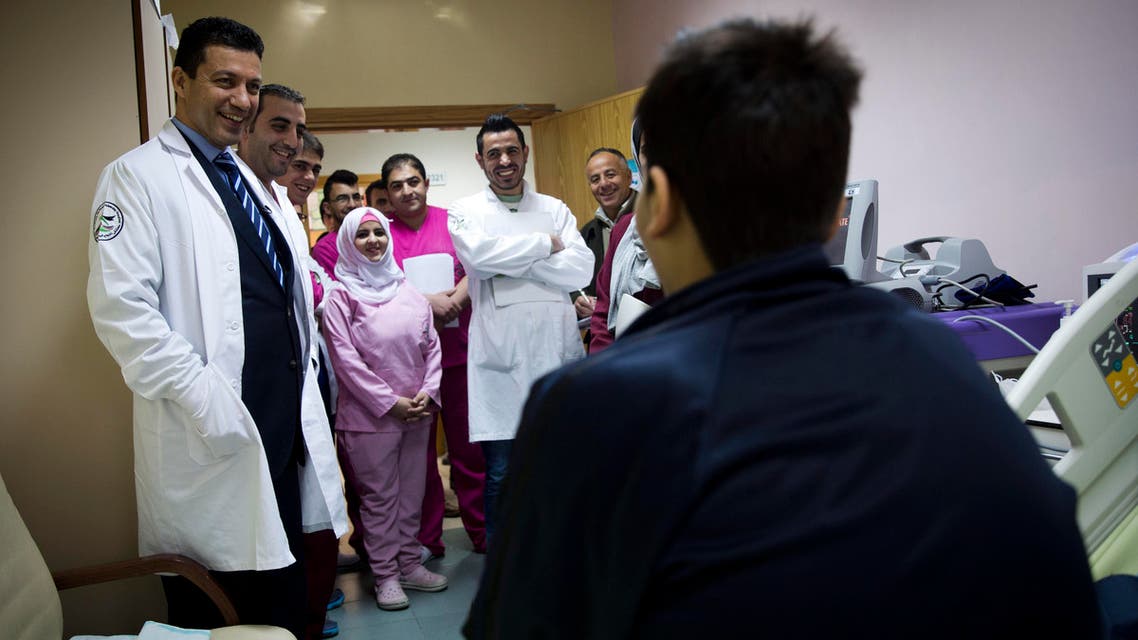 In this Thursday, Jan. 28, 2016 photo, Palestinian cardiovascular surgeon Saleem Haj-Yahia, left, visits 18-year-old Ahmad Sabareh recovering from heart transplant surgery at An-Najah University hospital in the West Bank city of Nablus. (AP)