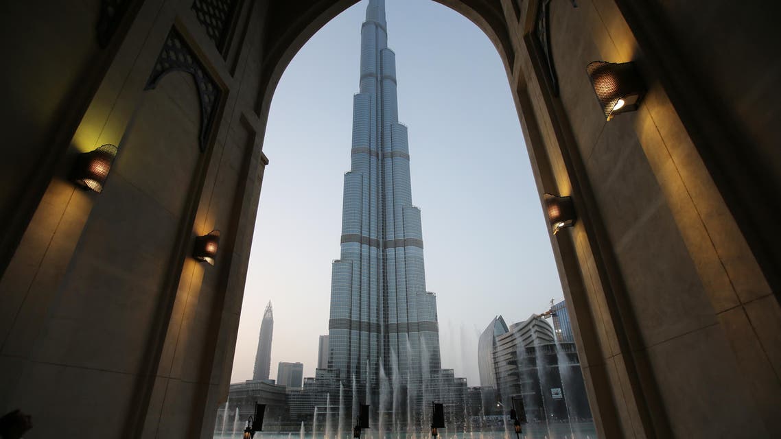 In this Monday, April 13, 2015, with the world tallest tower, Burj Khalifa, in the background, tourists and visitors watch and take photos of the Dubai Fountain in Dubai, United Arab Emirates. (AP)