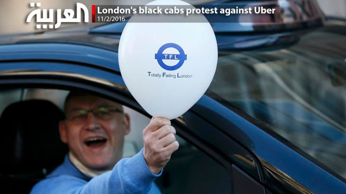 A London cab driver holds a balloon during a protest by London cab drivers against Uber in central London, Britain February 10, 2016 (Reuters)