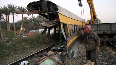 Egyptians railway workers attempt to remove debris from tracks following a train crash in Badrasheen, 40 KM south of Cairo, Egypt, Tuesday, Jan. 15, 2013.