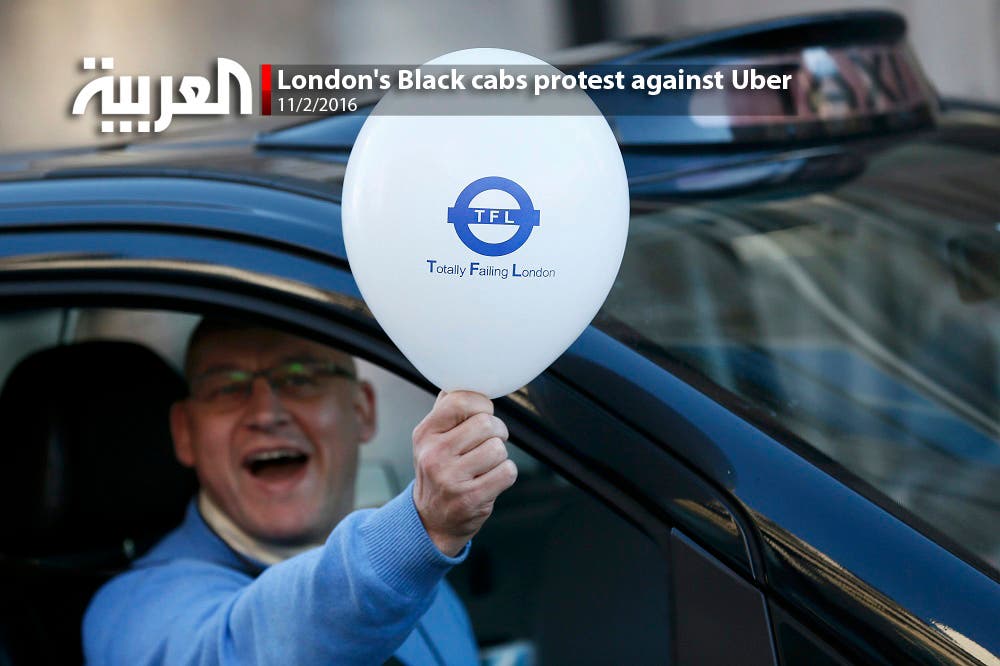 A London cab driver holds a balloon during a protest by London cab drivers against Uber in central London, Britain February 10, 2016 (Reuters)