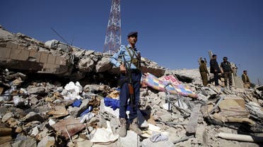 A policeman stands guard on the debris at the site of a Saudi-led air strike on the police headquarters in Yemen's capital Sanaa. (Reuters)