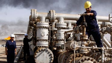 In this Dec. 13, 2009 file photo, Iraqi workers are seen at the Rumaila oil refinery, near the city of Basra, 550 kilometers southeast of Baghdad, Iraq. (AP)