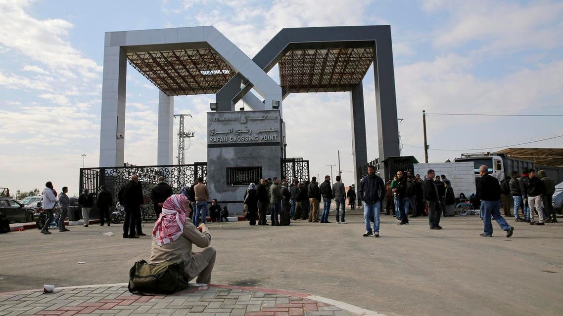 A Palestinian man and others wait outside the gate to cross the border to the Egyptian side at the Rafah crossing, in Rafah City, Gaza Strip, Thursday, Dec. 3, 2015. (AP)