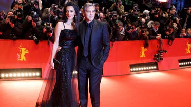 Cast member Clooney and his wife Amal arrive on red carpet for screening at opening gala of 66th Berlinale International Film Festival in Berlin. (Reuters)