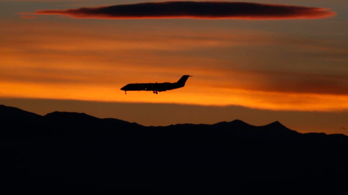 As the suns sets behind the mountains, a passenger plane comes in for a landing at Denver International Airport late Monday, Feb. 8, 2016, in Denver. AP