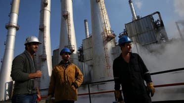 FILE - In this Dec. 22, 2014 file photo, Iranian oil workers gather at the Tehran's oil refinery south of the capital Tehran, Iran. Across a Mideast fueled by oil production, low global prices have some countries running on empty and scrambling to cover shortfalls, even as more regional crude is on tap to enter the market.(AP Photo/Vahid Salemi, File)