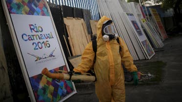 A municipal worker stands next to a banner that reads, "Rio Carnival 2016" before spraying insecticide at Sambodrome in Rio de Janeiro, Brazil, January 26, 2016.reuters