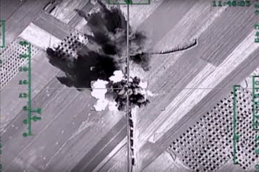In this photo made from the footage taken from Russian Defense Ministry official web site on Monday, Feb. 1, 2016, an aerial image shows what it says is a column of heavy trucks carrying ammunition hit by a Russian air strike near Aleppo, Syria. (AP)