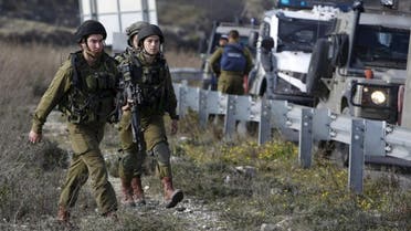 Israeli soldiers patrol at the scene where Israeli soldiers shot and killed a Palestinian 17-year-old in the West Bank town of Halhul, north of Hebron February 5, 2016. Israeli soldiers shot and killed a Palestinian 17-year-old in the occupied West Bank on Friday, hospital officials said, and the Israeli military said he had been about to throw a petrol bomb. REUTERS/Mussa Qawasma