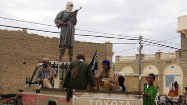 In this Aug. 31, 2012 file photo, fighters from the al-Qaida-linked Islamist group Ansar Dine stand guard in Timbuktu, Mali, as they prepare to publicly lash a member of the Islamic Police found guilty of adultery. (AP)