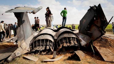 Libyans inspect the wreckage of a US F15 fighter jet after it crashed in an open field in the village of Bu Mariem, east of Benghazi, eastern Libya, Tuesday, March 22, 2011, with both crew ejecting safely. AP