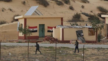 Egyptian policemen walk next to a border post, as seen from the Israeli side of the border with Egypt's Sinai peninsula, in Israel's Negev Desert February 10, 2016. REUTERS/Amir Cohen
