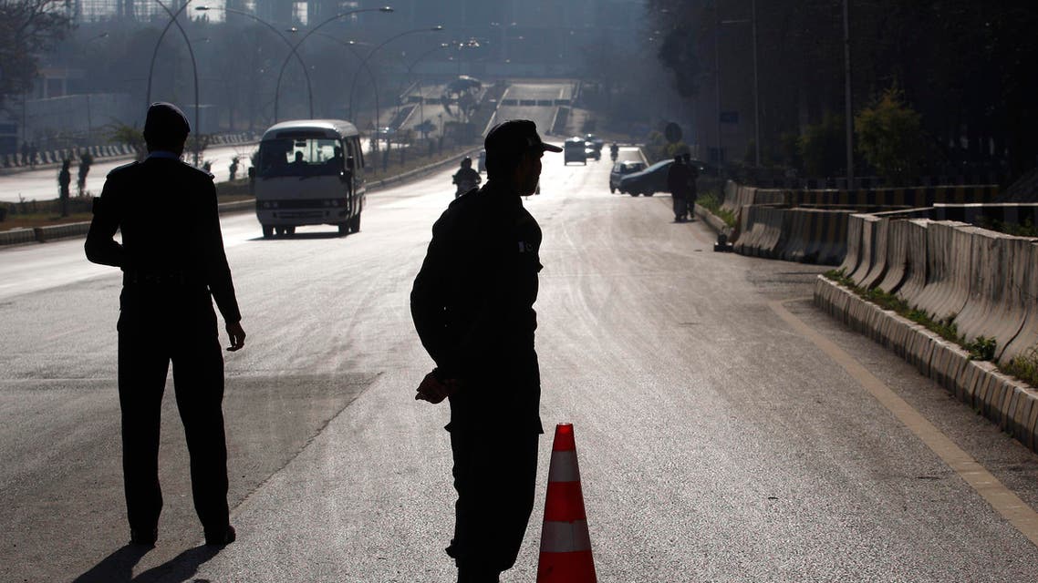 Pakistani police officers stand at a checkpoint outside the Foreign Ministry where a conference for Afghan peace process is going on, Monday, Jan. 11, 2016 in Islamabad, Pakistan.