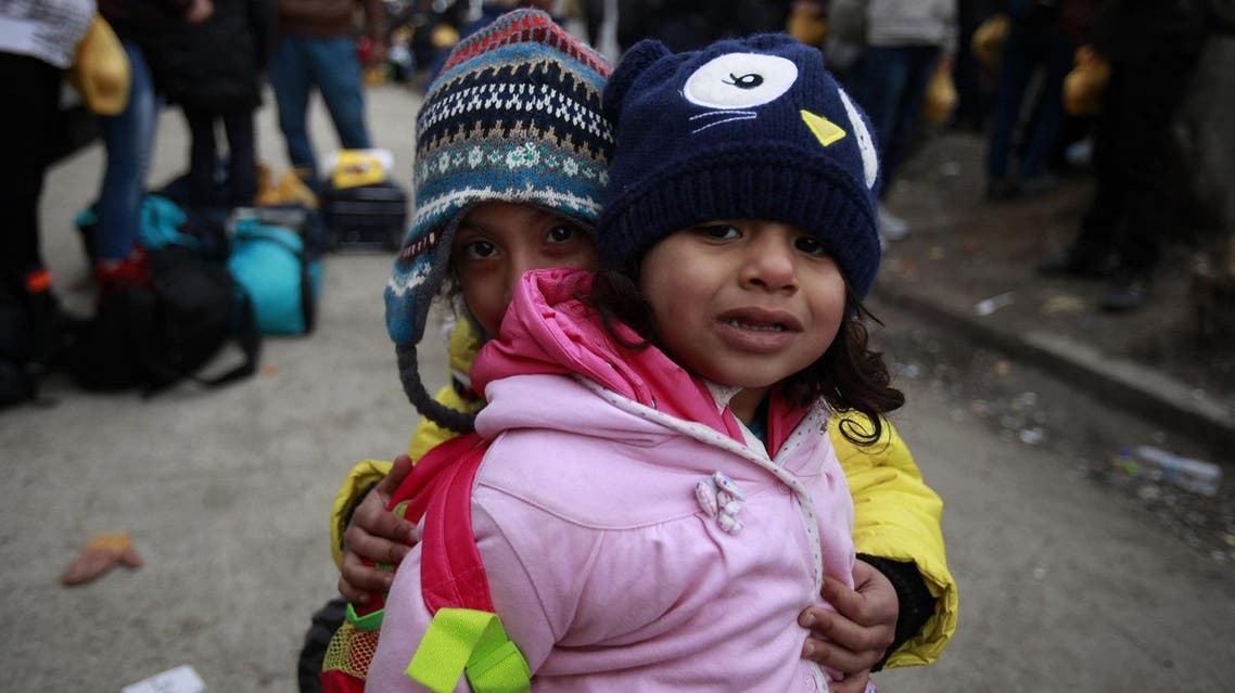 Refugee children wait for their family upon the arrival at the transit center for refugees near northern Macedonian village of Tabanovce, Wednesday, Feb. 10, 2016. (AP)