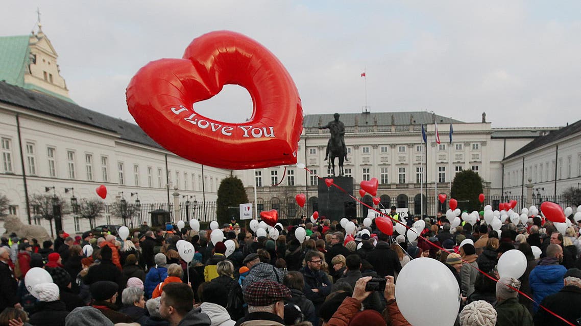 Supporters of the Committee for the Defense of Democracy movement wave balloons and stage a protest against the government, in front of the presidential palace, on Valentine's Day in Warsaw, Poland, Sunday, Feb. 14, 2016. (AP)