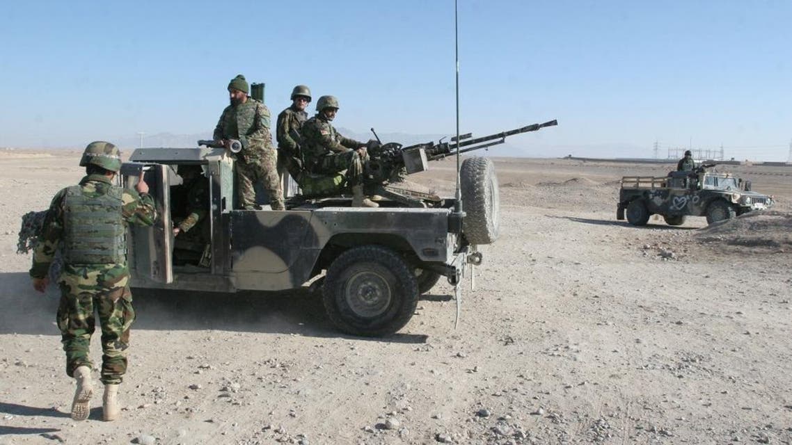 In this Wednesday, Dec. 23, 2015 file photo, Afghan National Army soldiers guard a checkpoint on the way to the Sangin district of Helmand province, Afghanistan. After months of ferocious fighting, Afghan army units battling the Taliban in southern Helmand province are facing major restructuring and leadership changes, with several key commanders being replaced, a U.S. military official said Monday, Jan. 25, 2016. (AP Photos/Abdul Khaliq, File)