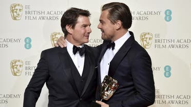 Leonardo DiCaprio holds his award for best leading actor as he embraces presenter Tom Cruise at the British Academy of Film and Television Arts (BAFTA) Awards at the Royal Opera House in London, February 14, 2016