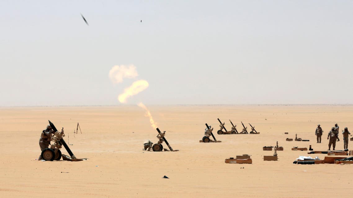 Saudi soldiers fire artillery towards the border with Yemen in Najran, Saudi Arabia, Tuesday, April 21, 2015. (AP