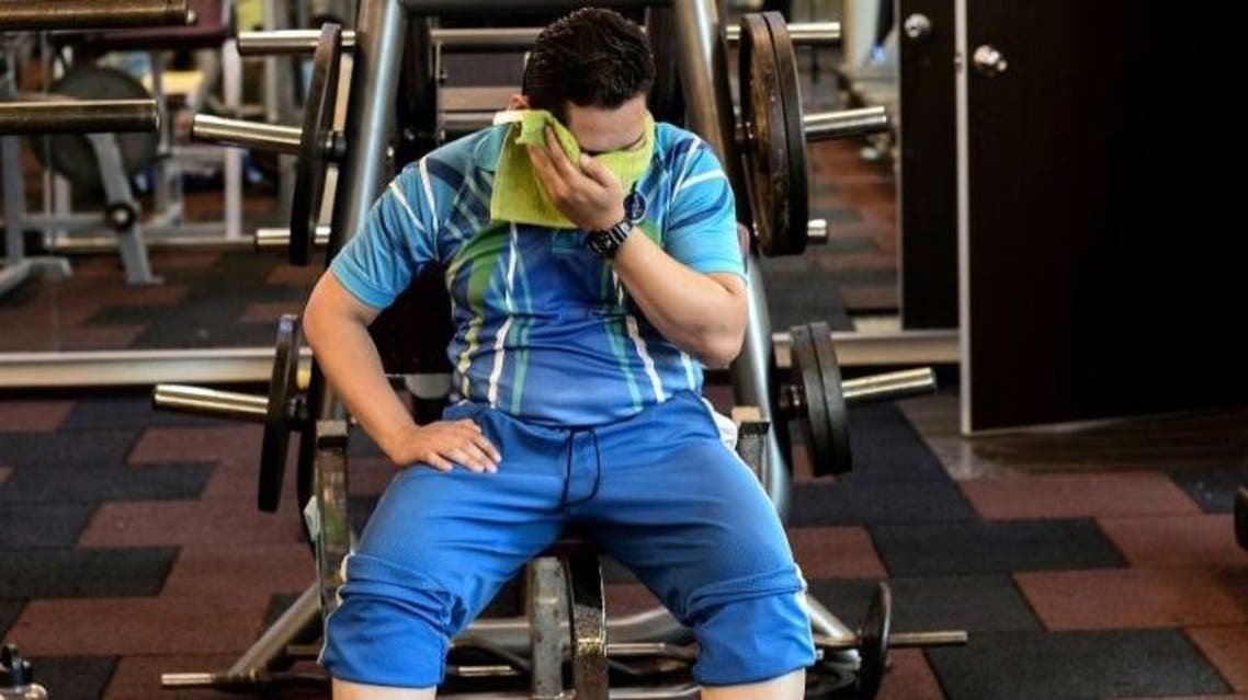 Malaysian police personnel resting between exercises as they take part in the special weight-loss and fitness program. (File Photo: AFP)