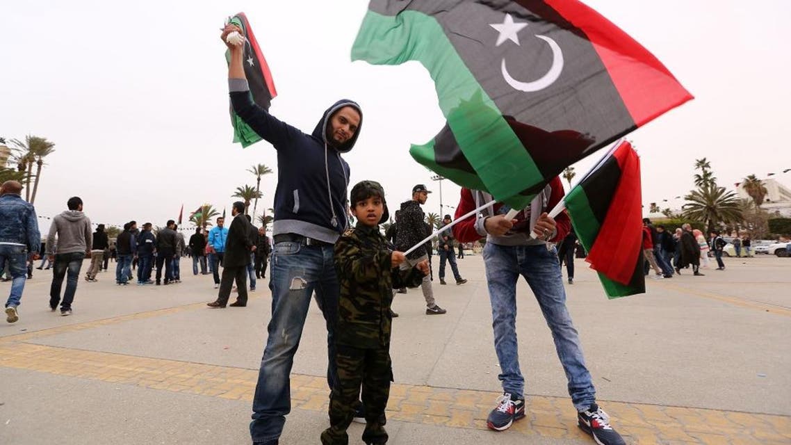 Libyans wave national flags as they gather at Martyrs' Square in the capital Tripoli on February 16, 2016 to attend the celebrations marking the fifth anniversary of the Libyan revolution which toppled strongman Moamer Kadhafi. Five years after the death of dictator Moamer Kadhafi, many Libyans have lost hope of seeing the rule of law return to a divided country threatened by jihadist expansion. / AFP / MAHMUD TURKIA