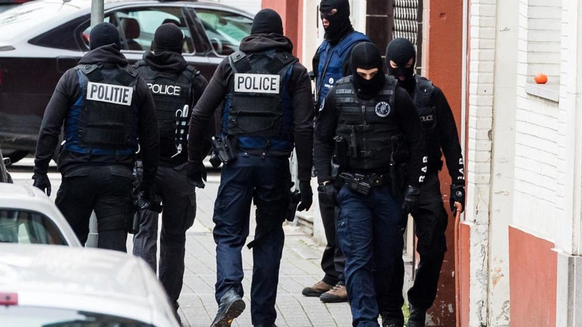 In this Monday, Nov. 16, 2015 file photo, armed police guard a street in Brussels. The Belgian government on Friday, Feb. 5, 2016 adopted a plan to combat rising Islamic radicalism in some neighborhoods of Brussels by using local police to monitor suspicious individuals, mosques and prayer rooms. (AP Photo/Geert Vanden Wijngaert, File)