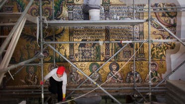 Restoration experts work on mosaic inside the Church of the Nativity, in the West Bank city of Bethlehem. (AP)