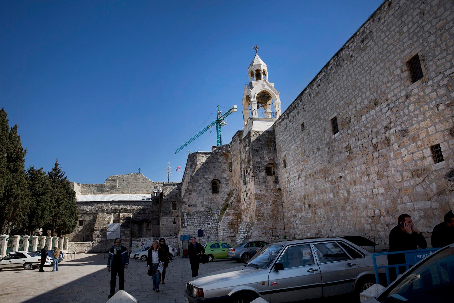 tourists walk at the Manger Square of the Church of the Nativity in the West Bank city of Bethlehem. (AP)