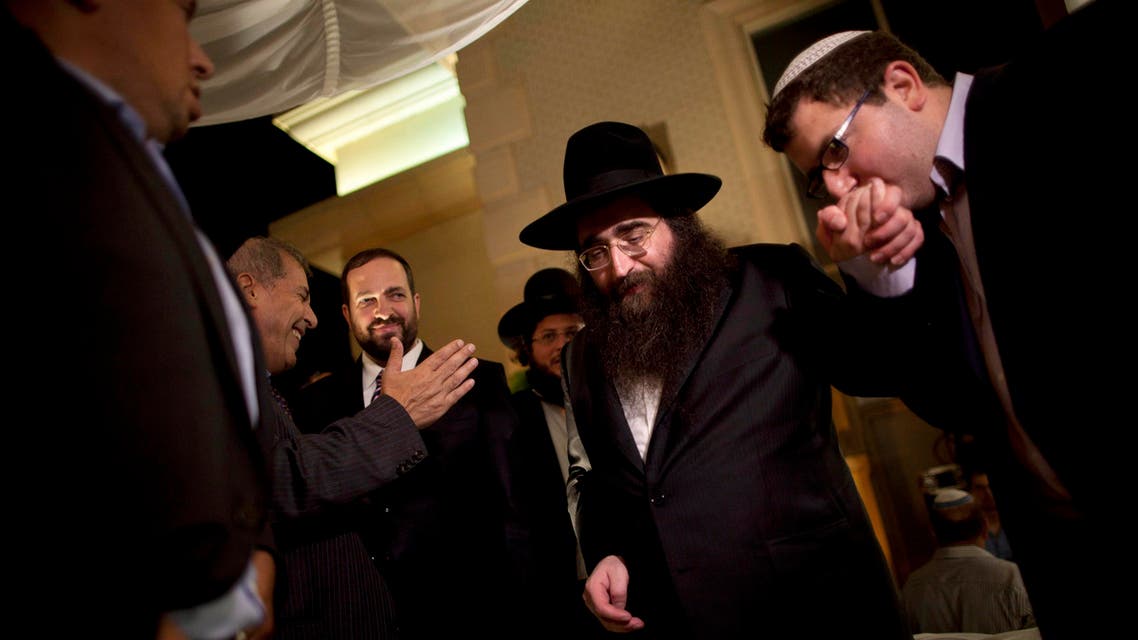 FILE - In this July 11, 2011 file photo, a man kisses the hand of Rabbi Yoshiyahu Pinto at a wedding in Lod, central Israel. An Israeli prison spokeswoman said Pinto, a celebrity rabbi with a following in the United States, has reported to prison on Tuesday, Feb. 16, 2016, to begin a one-year sentence for bribery. (AP Photo/Oded Balilty, File)