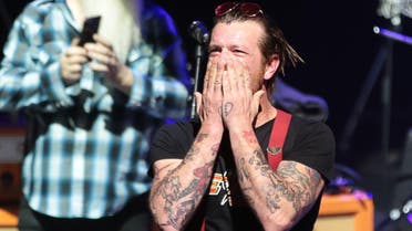 Jesse Hughes (R), the singer of US rock group Eagles of Death Metal, blows a kiss before the start of the concert at the Olympia concert hall in Paris. (AFP)