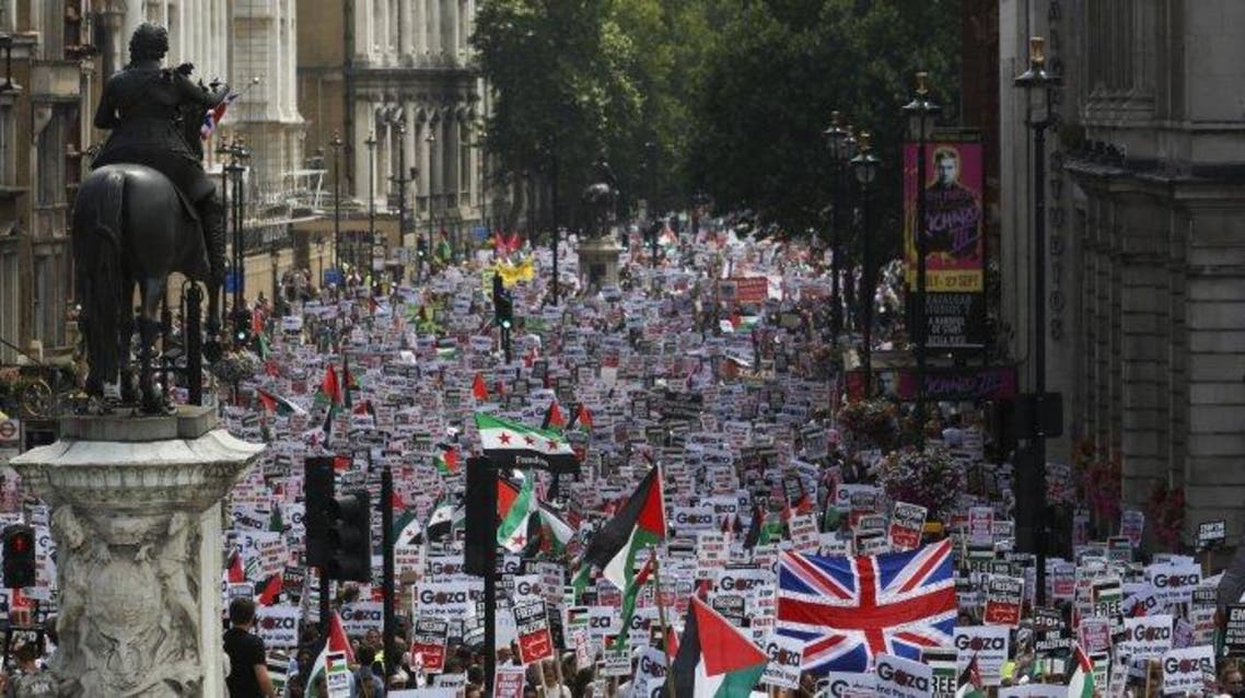 Demonstrators protest against Israel's military action in Gaza, in Whitehall, London, July 19, 2014. The British government is to ban local authorities and public sector organizations from boycotting Israeli suppliers.