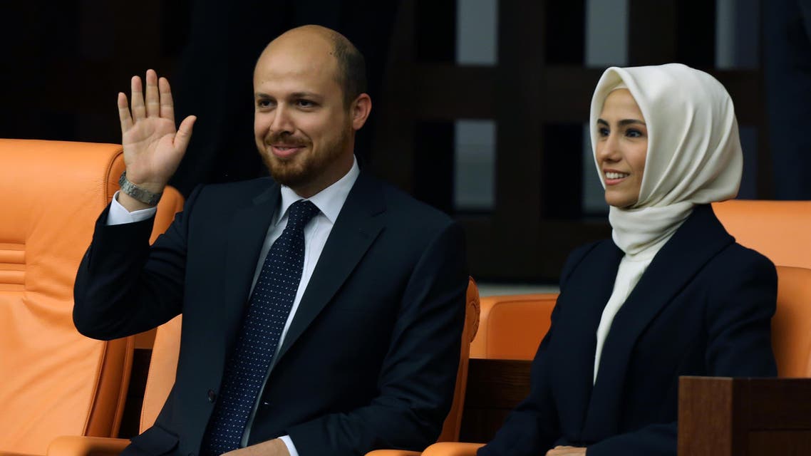 Recep Tayyip Erdogan's son, Bilal Erdogan, left, and daughter, Sumeyye Erdogan, smile as their father takes the oath of office at the parliament in Ankara, Turkey, Thursday, Aug. 28, 2014. AP
