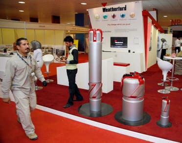 A security guard walks past the Weatherford booth during the Basra International trade fair for oil and gas in Basra, Iraq in a November 25, 2010 file photo. (Reuters)
