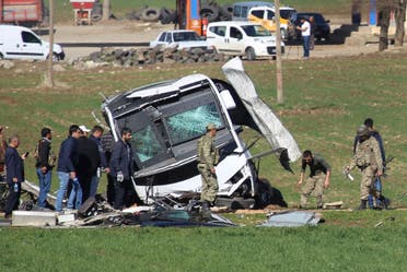Members of Turkish forces gather around a bus that was destroyed in an explosion on the road linking the cities of Diyarbakir and Bingol, in southeastern Turkey, Thursday, Feb. 18, 2016. Six soldiers were killed after PKK rebels detonated a bomb on the road as their vehicle was passing by, according to Turkey’s state-run Anadolu Agency.The deaths come a day after a suicide bombing claimed the lives of at least 28 people and wounded dozens of others. (AP Photo/Mahmut Bozarslan)