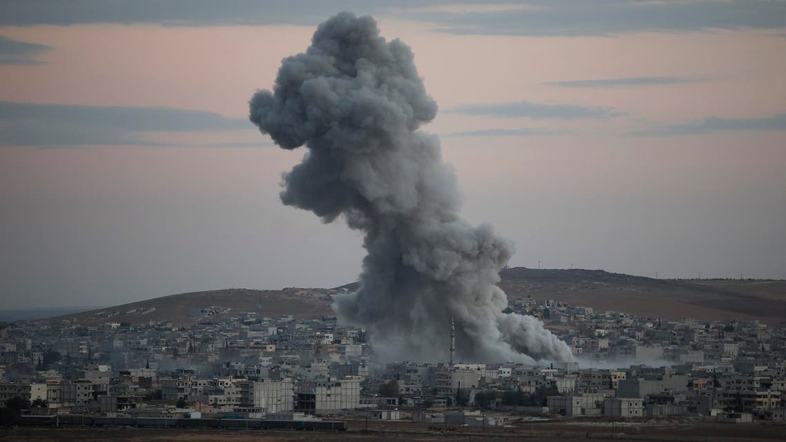 Thick smoke from an airstrike by the US-led coalition rises in Kobani, Syria while fighting continued between Syrian Kurds and the militants of Islamic State group, as seen from Mursitpinar on the outskirts of Suruc, at the Turkey-Syria border, Saturday, Oct. 18, 2014. AP