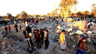 Libyans gather next to debris at the site of a jihadist training camp, targeted in a US air strike, near the Libyan city of Sabratha on February 19, 2016 (AFP)