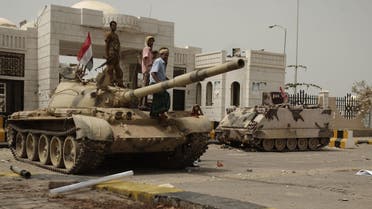 army soldiers and tribesmen loyal to the army gather on a tank in front of the local authority compound in the city of Zinjibar, Yemen after they retook the city from al-Qaida militants, Thursday, June 14, 2012. AP