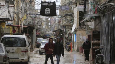 Youth walk under an Islamic State flag in Ain al-Hilweh Palestinian refugee camp, near the port-city of Sidon, southern Lebanon January 19, 2016. (Reuters)