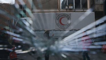 A Red Crescent aid convoy is pictured through a broken windshield in the rebel held besieged city of Douma, a suburb of Damascus February 13, 2016. Reuters