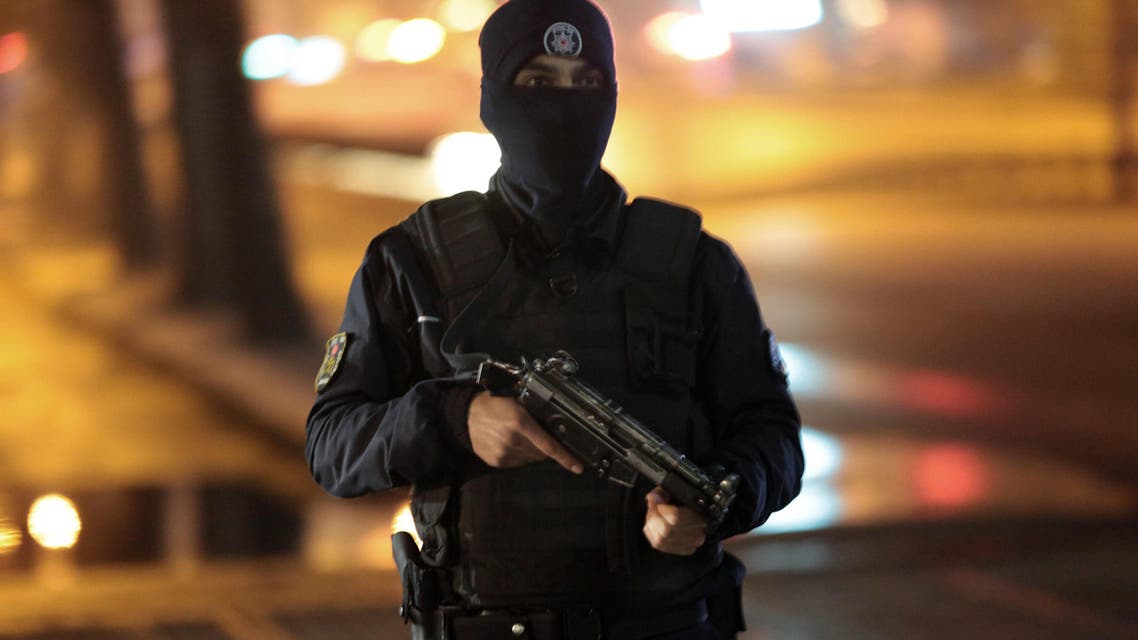 A police officer stands as security officials close the main roads around an explosion site in Ankara, Turkey, Wednesday, Feb. 17, 2016. (AP)