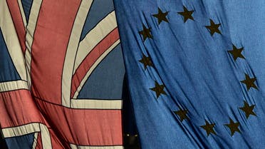 A British Union flag and a European Union flag hang from a building in central London. (Reuters)