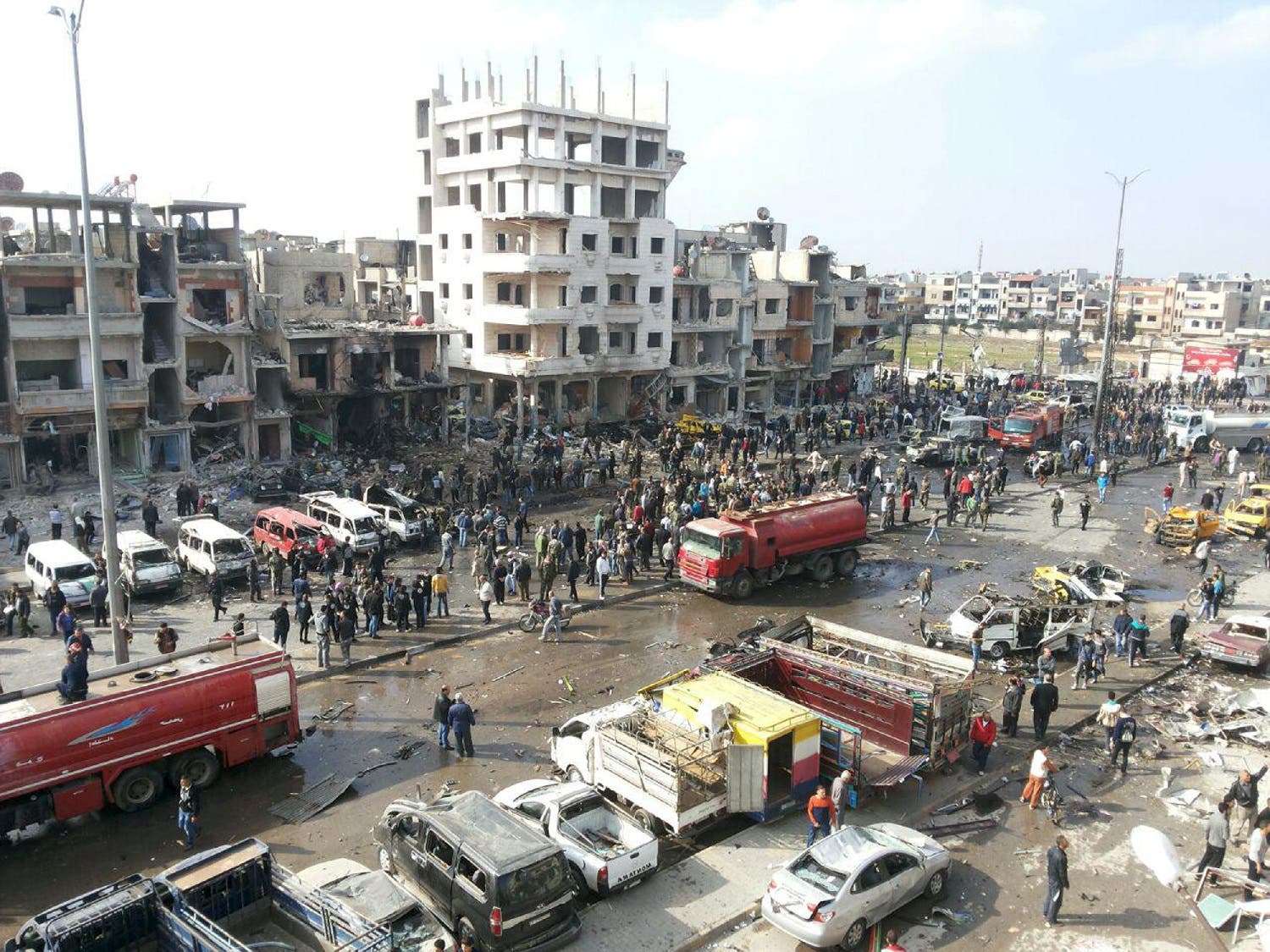 A general view shows the site of a two bomb blasts in the government-controlled city of Homs, Syria, in this handout picture provided by SANA on February 21, 2016. REUTERS