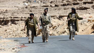 Pro-government army soldiers walk on a road in Fardhat Nahm area, which has recently been taken by the army from Houthi rebels, around 60km (40 miles) from Yemen's capital Sanaa, February 20, 2016. REUTERS