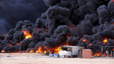 Smoke rises from burning oil storage tanks in the port of Ras Lanuf, Libya, January 23, 2016. REUTERS/Stringer