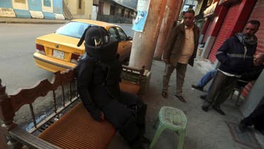 Iraqi artist Hussein Adil's bomb suit performance. (AFP)