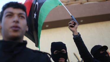 Libyan security forces stand in front of the security headquarters, one showing his weapon with a Libyan flag, in the western city of Sabratha, Libya, Saturday, Feb. 20, 2016. (File photo: AP)
